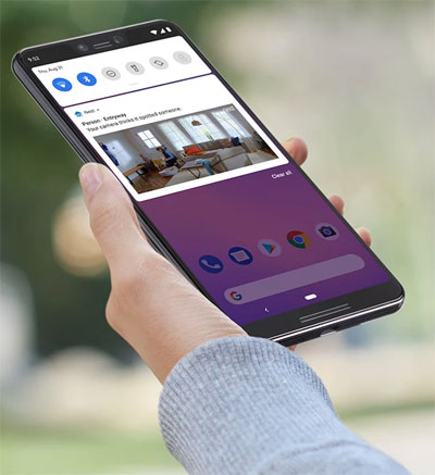  An Android phone held by a hand, with the screen showing camera live feed  